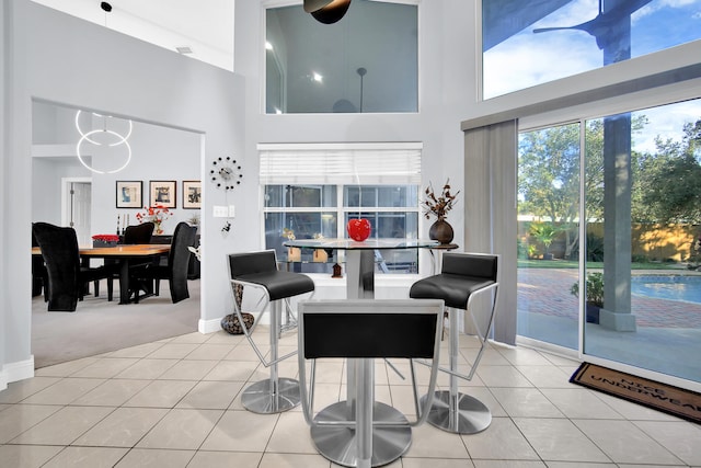 tiled living room with a high ceiling