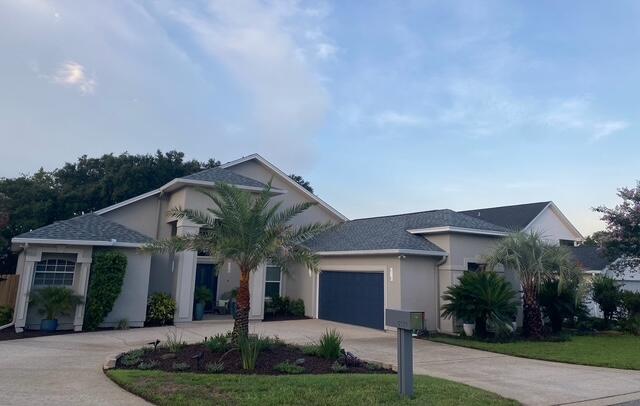 view of front of property with a front lawn and a garage