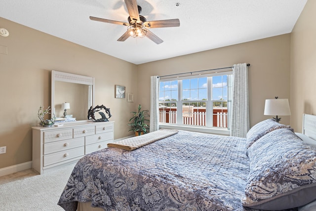 bedroom with light carpet, a textured ceiling, and ceiling fan