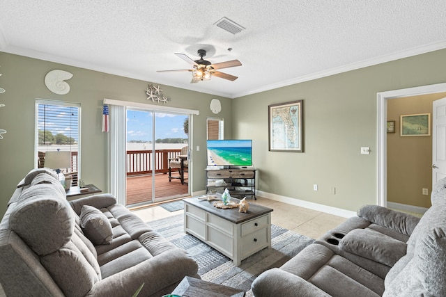 living room with light tile patterned floors, a textured ceiling, ceiling fan, and crown molding