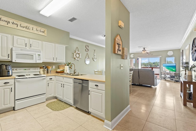 kitchen with white appliances, ceiling fan, sink, light tile patterned floors, and white cabinets