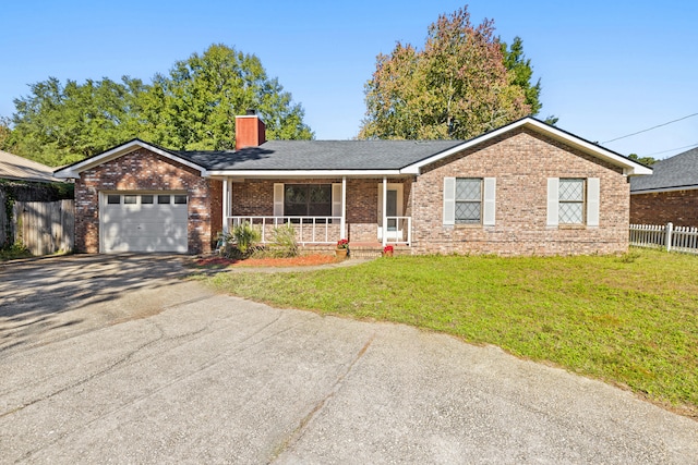 ranch-style house featuring a front yard, a porch, and a garage