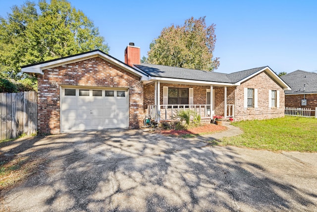 ranch-style house featuring a porch and a garage