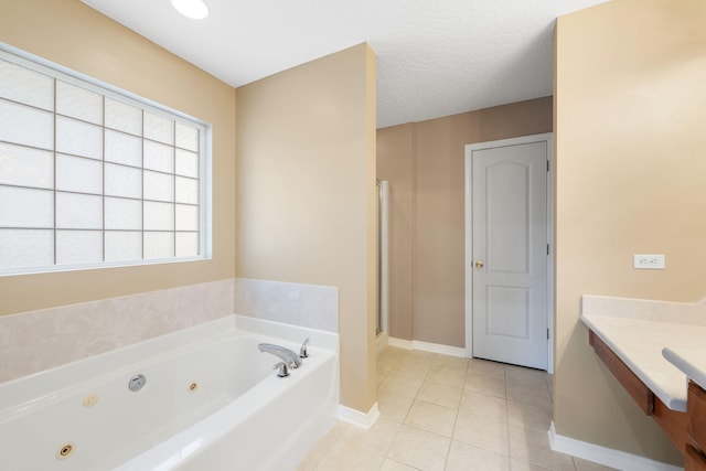 bathroom featuring tile patterned floors, vanity, shower with separate bathtub, and a textured ceiling