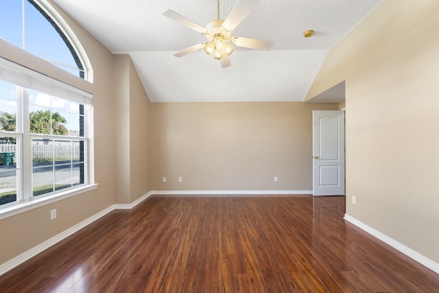 bonus room with lofted ceiling, ceiling fan, dark wood-type flooring, and a textured ceiling