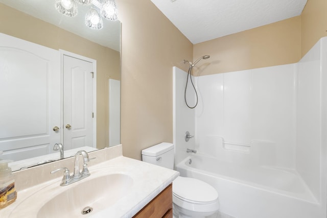 full bathroom featuring vanity, toilet, a textured ceiling, and shower / washtub combination