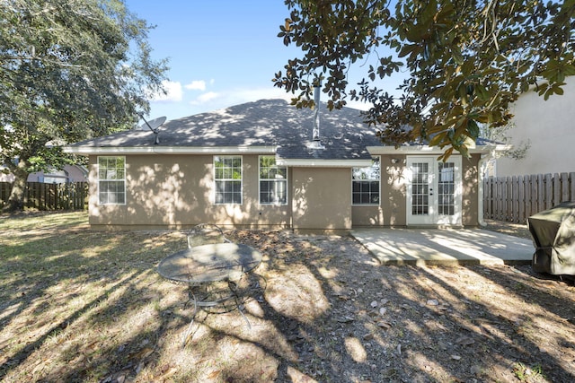 rear view of house with french doors and a patio