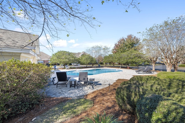 view of swimming pool featuring a lawn and a patio