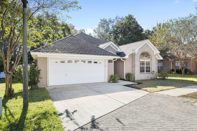 single story home featuring a front yard and a garage