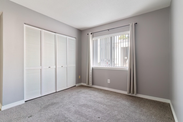 unfurnished bedroom featuring carpet and a closet