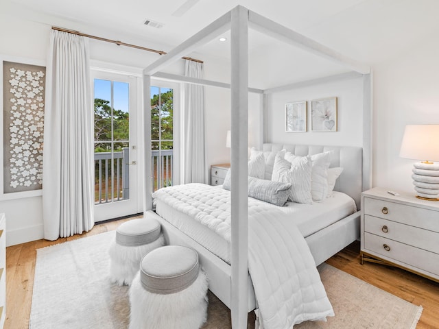 bedroom featuring light wood-type flooring and access to outside