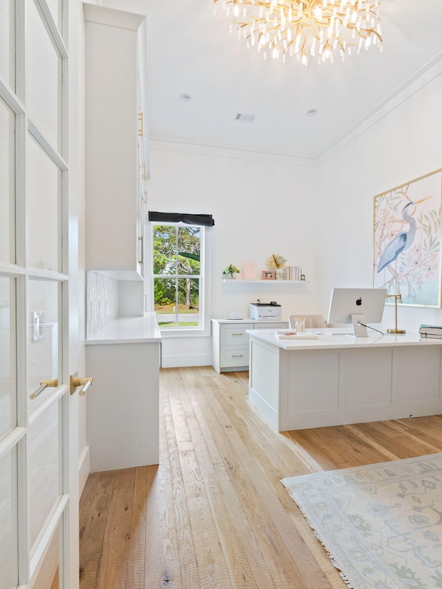 bathroom with wood-type flooring, a notable chandelier, and ornamental molding