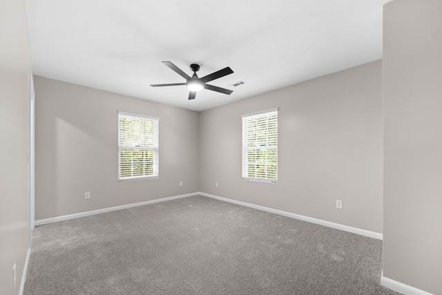 carpeted empty room featuring ceiling fan