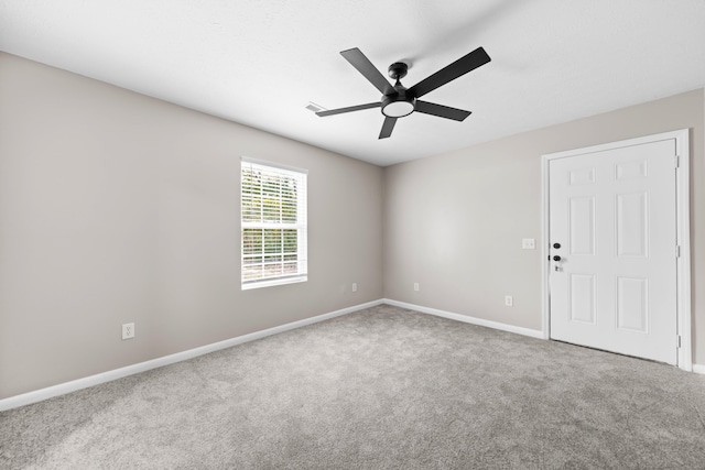 carpeted spare room with ceiling fan