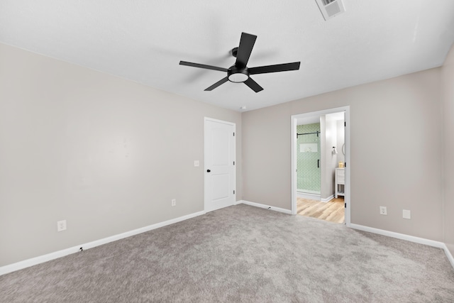 unfurnished room featuring ceiling fan and light carpet