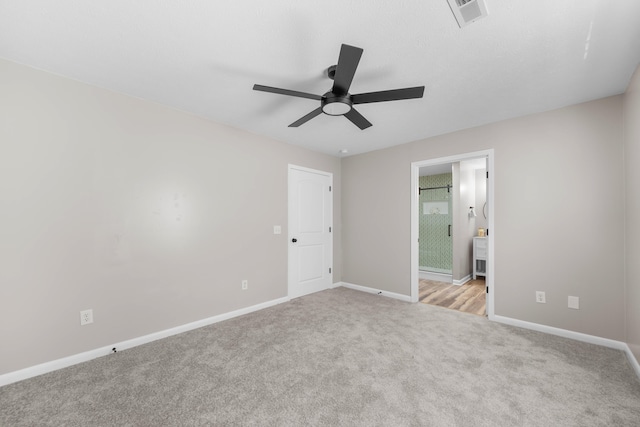 unfurnished room with ceiling fan and light carpet