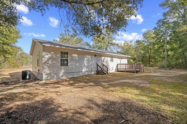 back of house with a wooden deck and central air condition unit