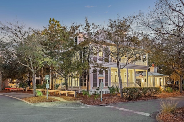 11 Acorn Way, Santa Rosa Beach, FL 32459 - view of property hidden behind natural elements with a porch, a balcony, and a chimney