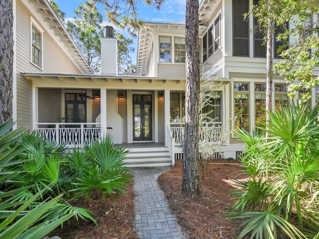 11 Acorn Way, Santa Rosa Beach, FL 32459 - property entrance with covered porch, a chimney, and french doors