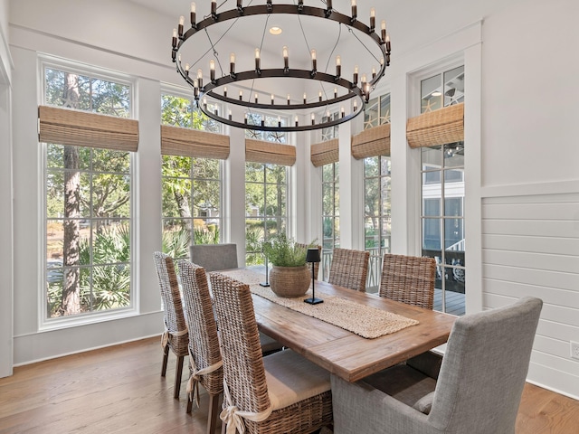 sunroom featuring plenty of natural light and an inviting chandelier