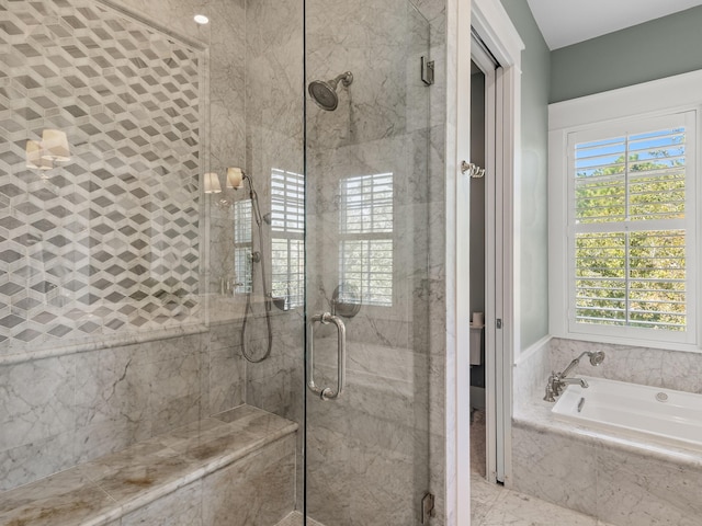 bathroom with separate shower and tub and a wealth of natural light