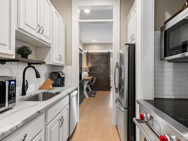 11 Acorn Way, Santa Rosa Beach, FL 32459 - kitchen featuring stainless steel appliances, open shelves, a sink, white cabinets, and decorative backsplash