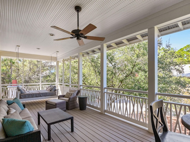 wooden deck featuring outdoor lounge area and ceiling fan