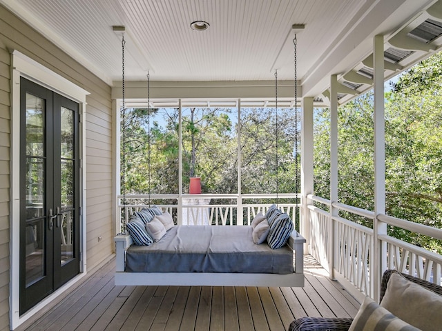 unfurnished sunroom with french doors