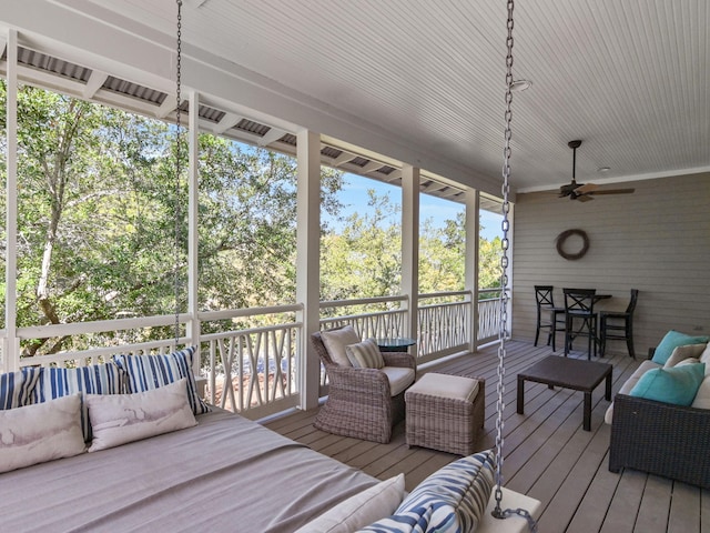 sunroom with ceiling fan