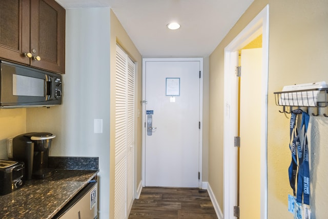 hallway with dark hardwood / wood-style flooring