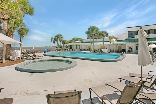 view of pool with a community hot tub and a patio