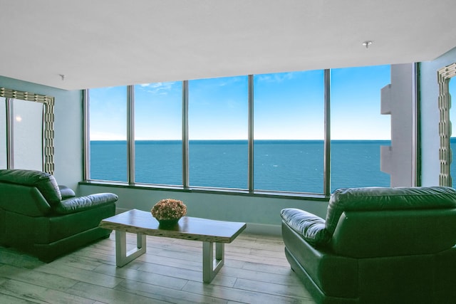 sunroom featuring a water view