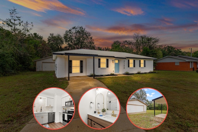 ranch-style home featuring a yard, sink, an outbuilding, and a garage