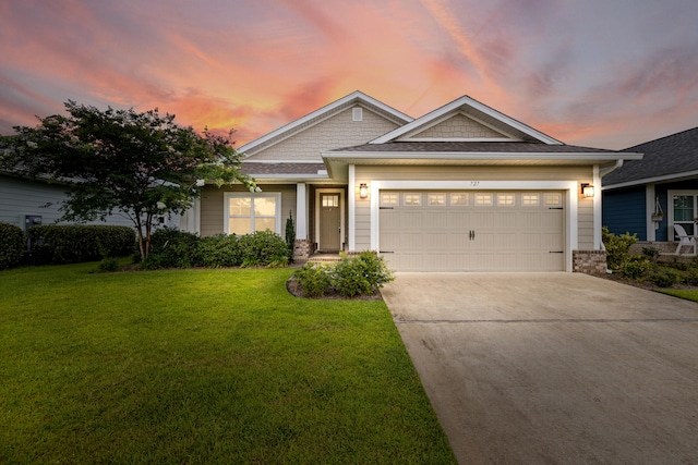 craftsman-style home featuring a garage and a lawn