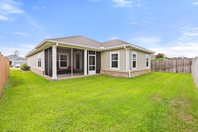 back of house with a lawn and a sunroom