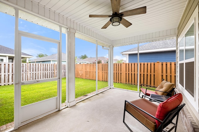 sunroom / solarium featuring ceiling fan