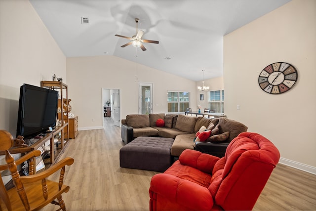 living room featuring ceiling fan with notable chandelier, light hardwood / wood-style flooring, and lofted ceiling