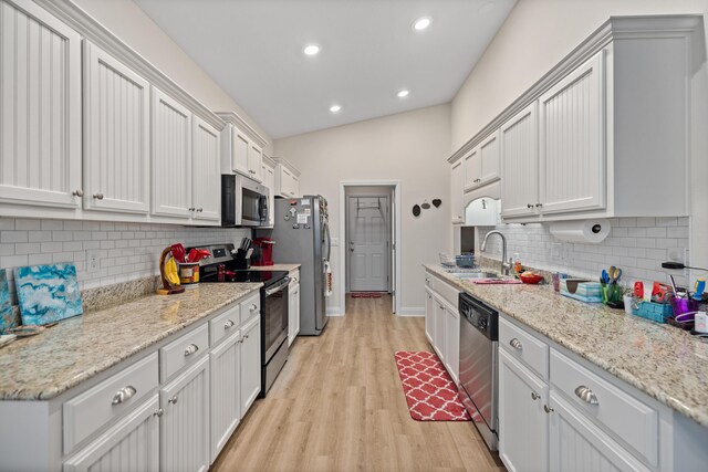 727 Marquis Way, Freeport, FL 32439 - kitchen featuring appliances with stainless steel finishes, backsplash, light wood-style floors, a sink, and recessed lighting