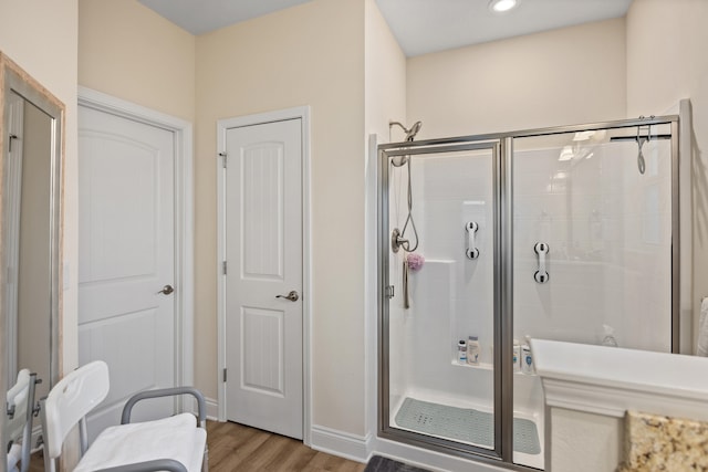 bathroom with hardwood / wood-style floors and walk in shower