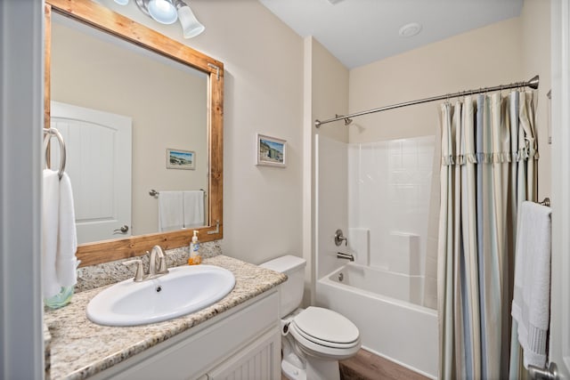 full bathroom featuring hardwood / wood-style flooring, vanity, toilet, and shower / tub combo with curtain