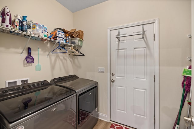 727 Marquis Way, Freeport, FL 32439 - clothes washing area with independent washer and dryer and wood finished floors