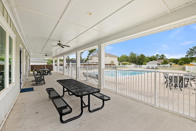 view of patio / terrace with ceiling fan and a community pool