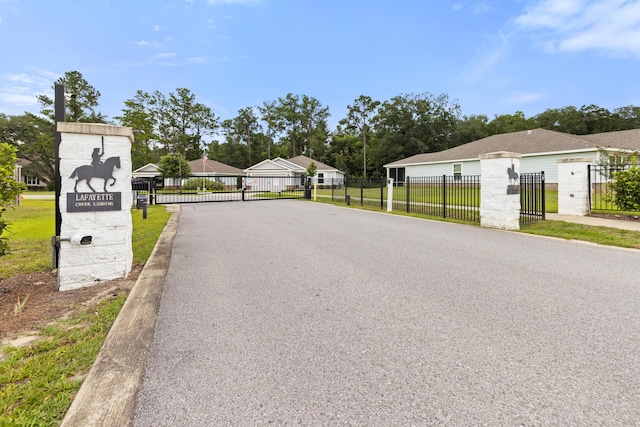 727 Marquis Way, Freeport, FL 32439 - view of asphalt street with a gate, a gated entry, a residential view, and curbs