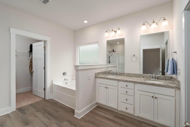 bathroom with vanity, hardwood / wood-style flooring, and separate shower and tub