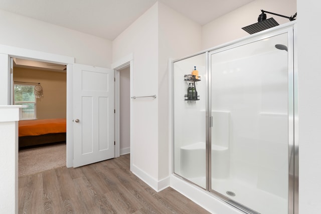 bathroom featuring wood-type flooring and a shower