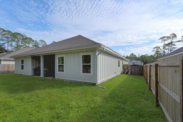 rear view of property with a lawn