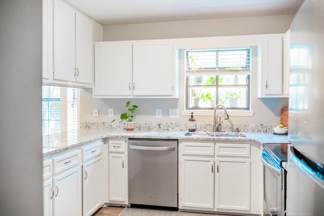 kitchen featuring electric range, white cabinetry, stainless steel dishwasher, and sink