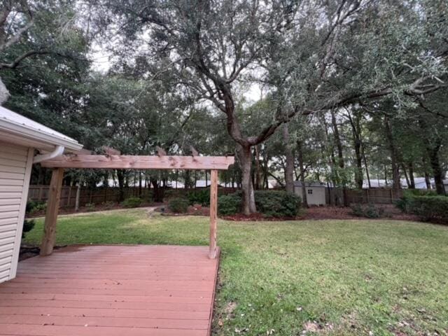 exterior space featuring a fenced backyard, a shed, an outbuilding, and a wooden deck