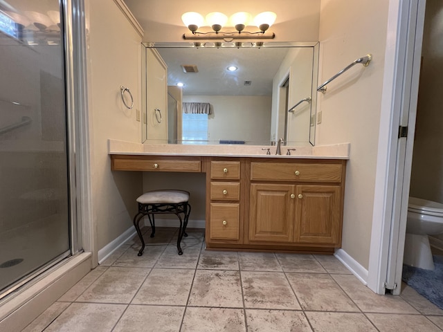 full bathroom featuring a stall shower, vanity, toilet, and tile patterned floors