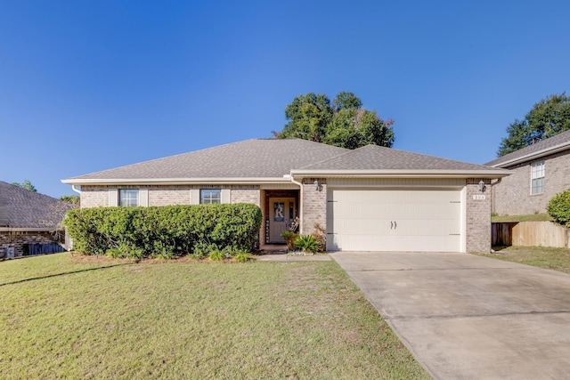 ranch-style home with a garage and a front yard